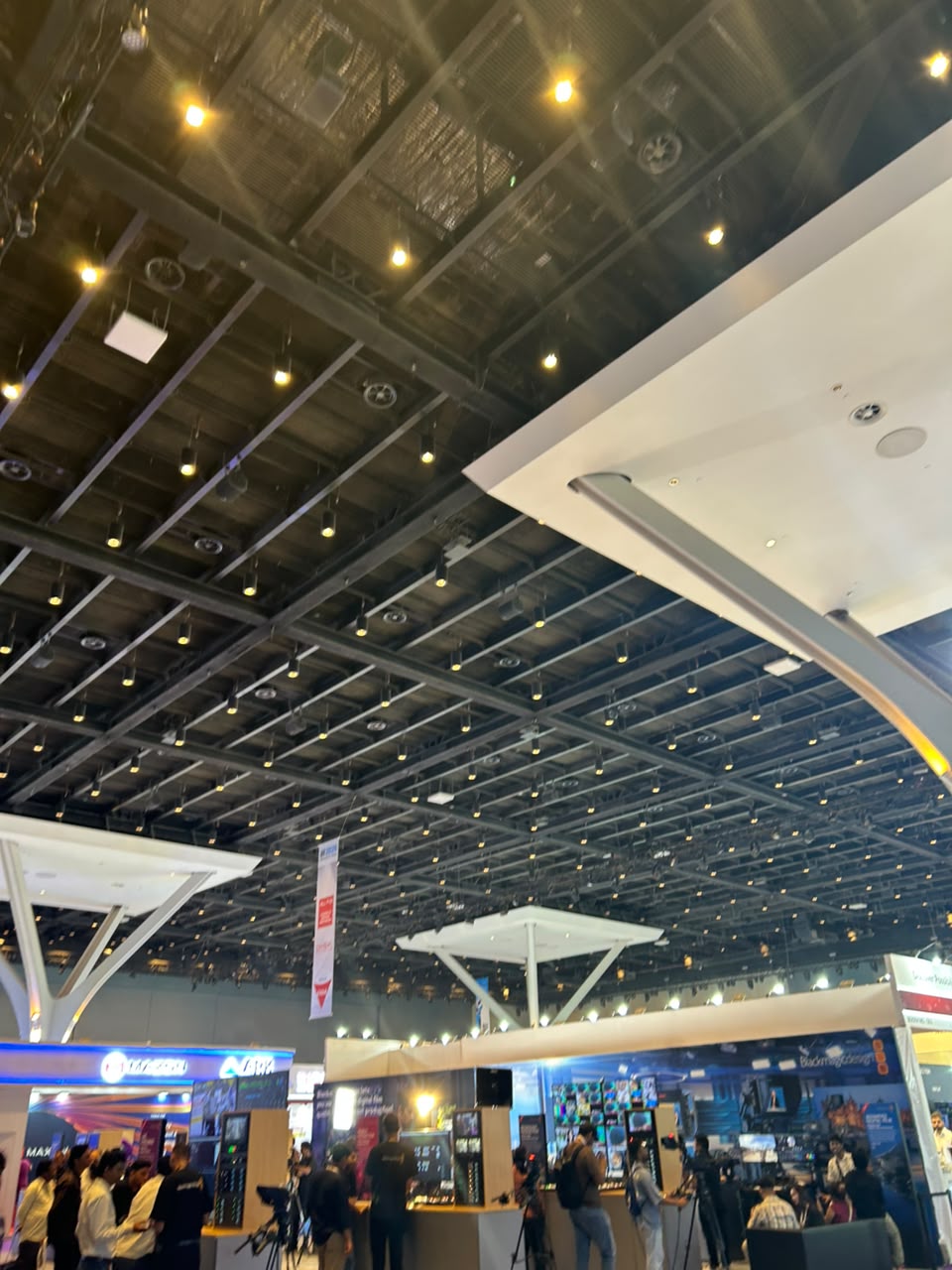 Exhibition hall with attendees and technology booths